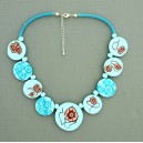 collier perles plates  fond turquoise clair fleur marron